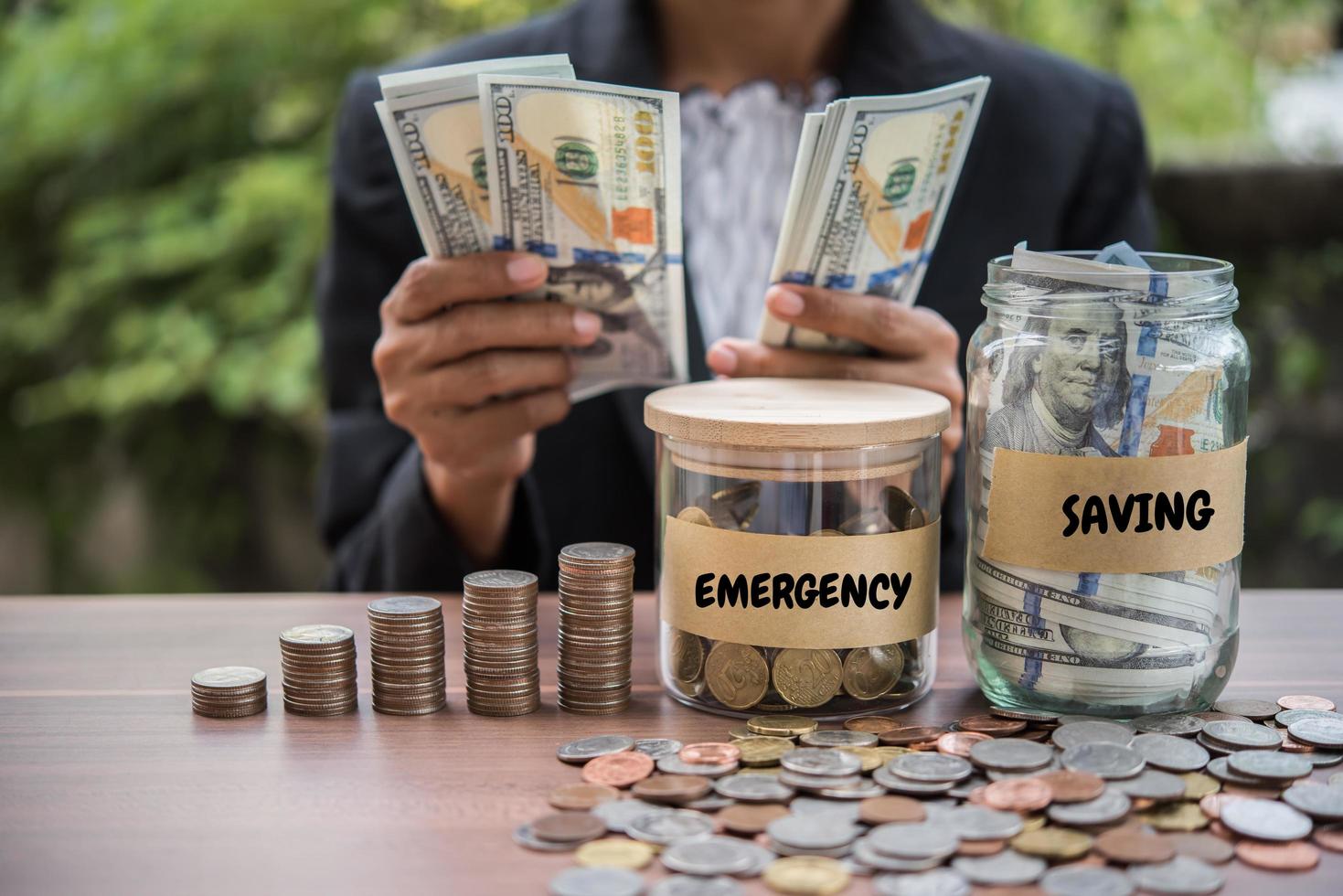 Woman counting cash money at a table outdoors photo