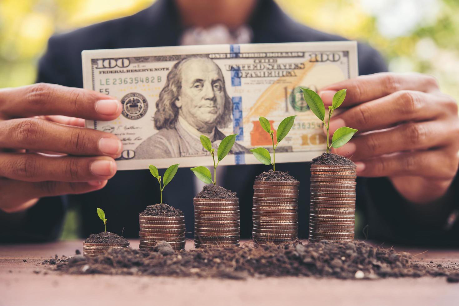 Woman counting cash money at a table outdoors photo