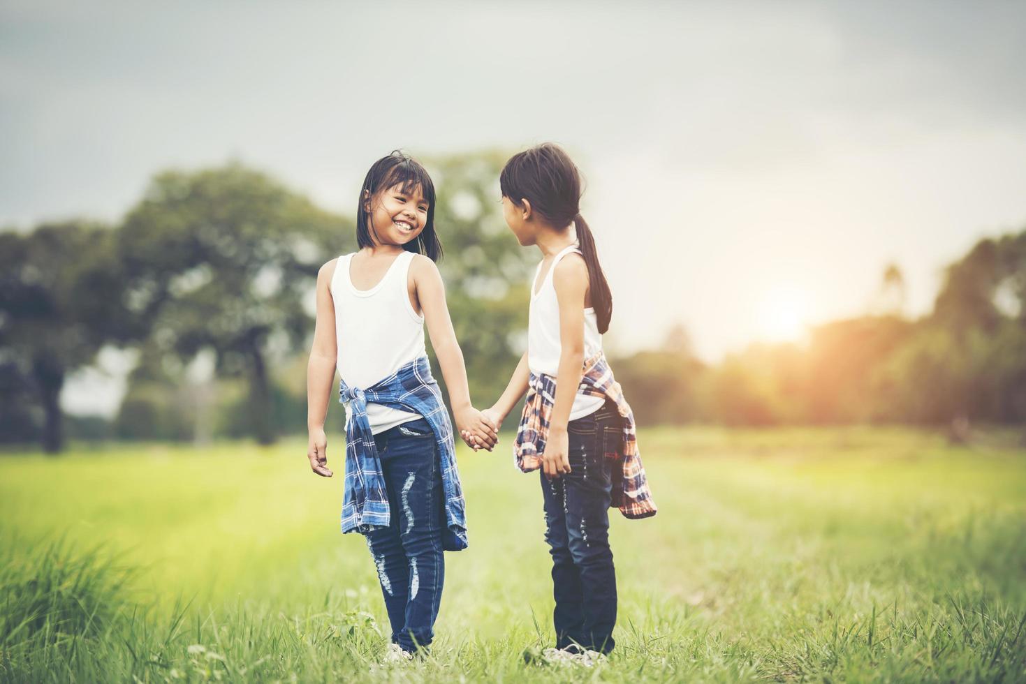 Two little girls having fun in the park photo