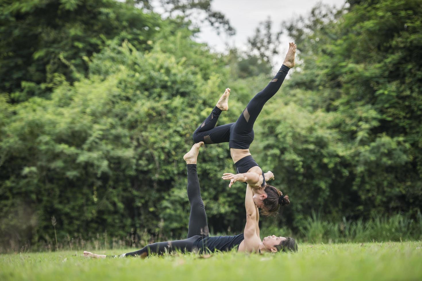 pareja haciendo yoga en el parque foto