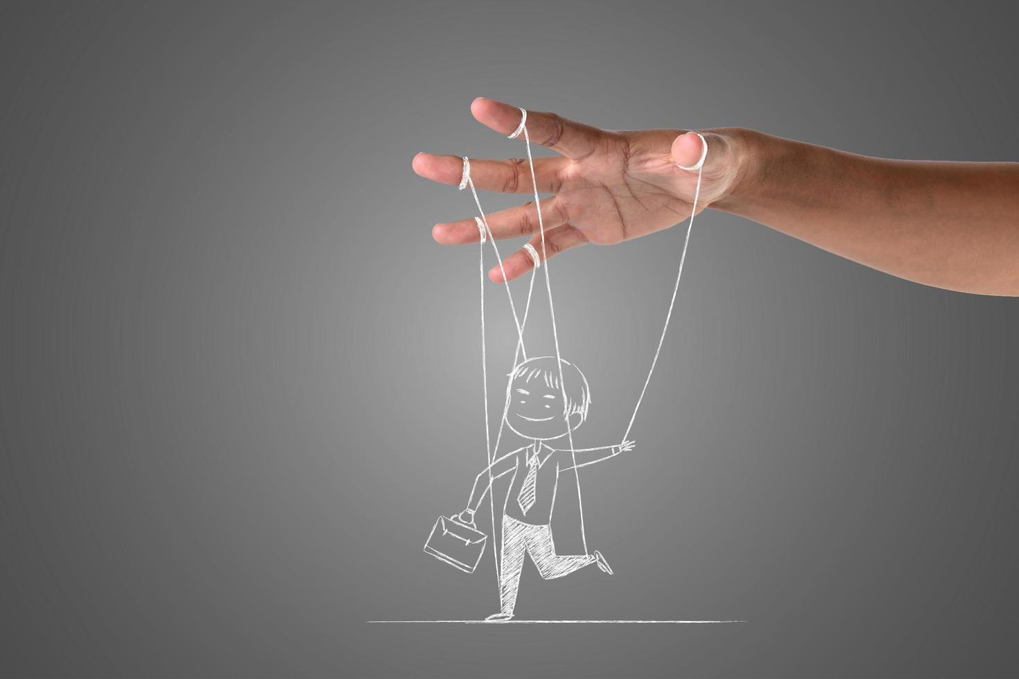 Hand holding chalk drawn figure on neutral background photo