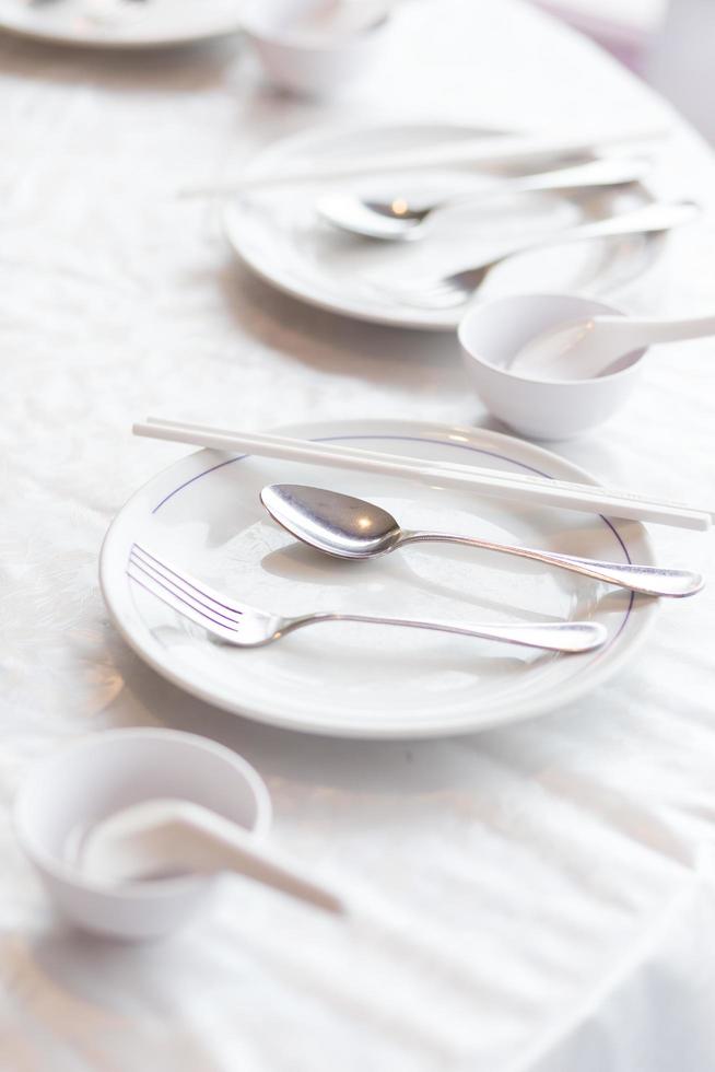 Plate of cutlery and chopsticks photo