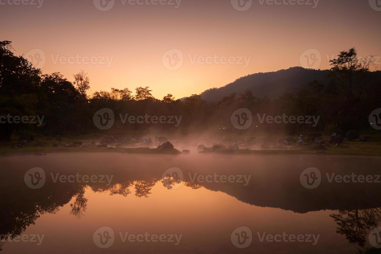 Colorful sunrise sky reflecting on dam photo