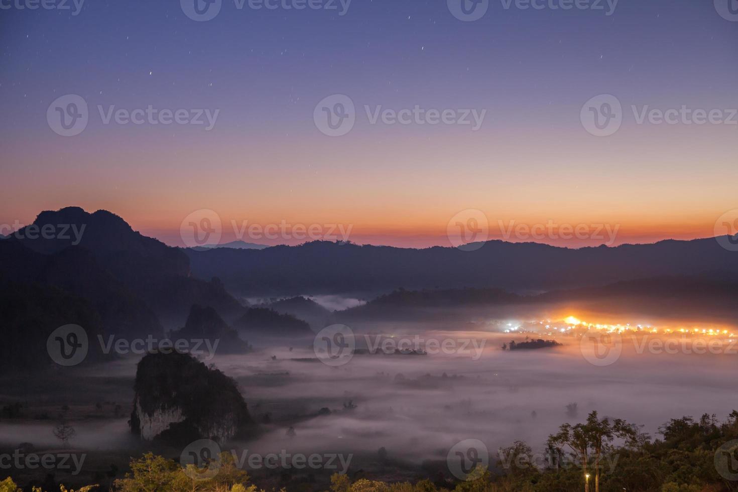 City lights in fog at sunset photo