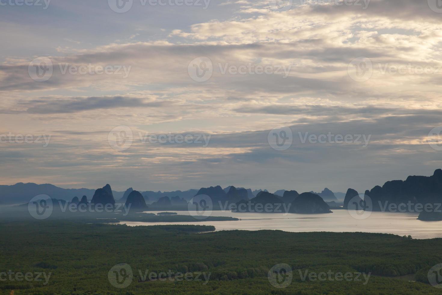 Sunrise above mountains and water photo