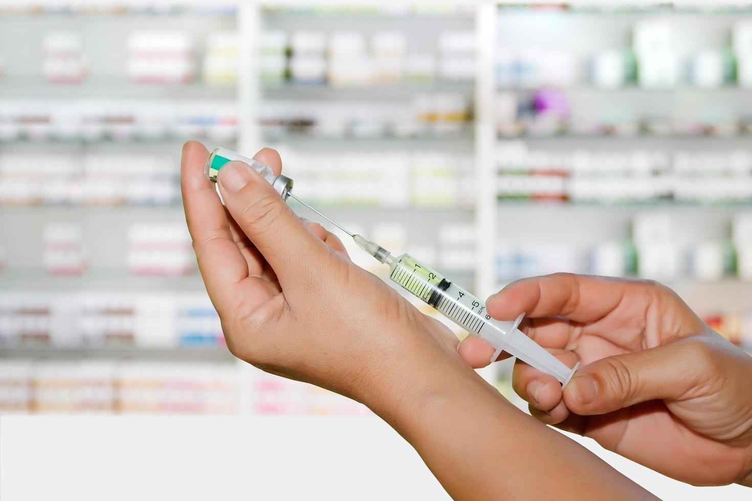 Doctor's hands filling a syringe photo