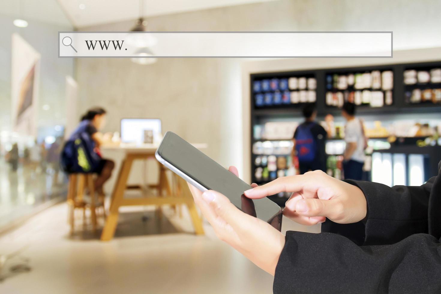 Person using a tablet inside of a store or cafe photo