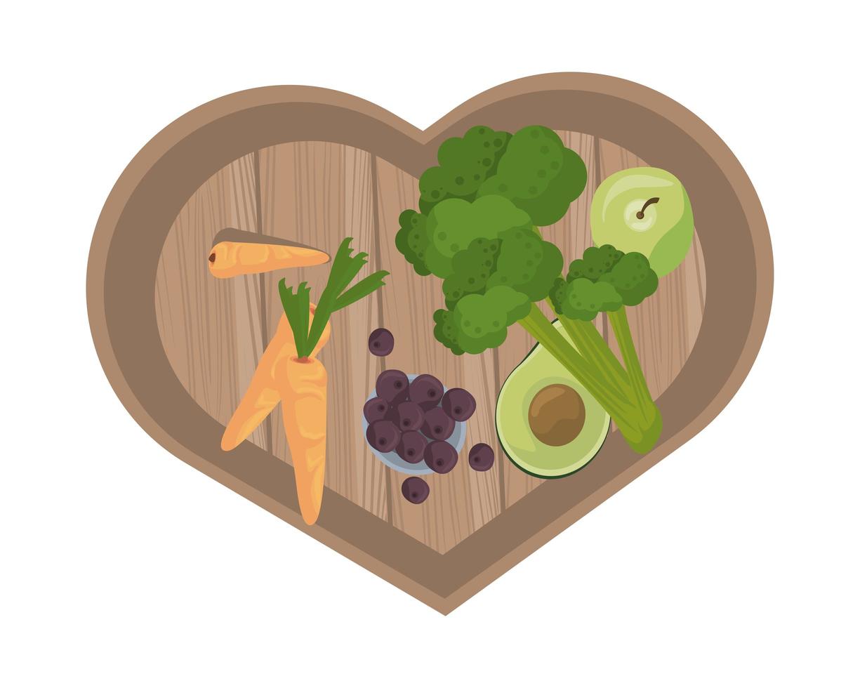 Verduras y zanahorias sobre tablero de cocina de madera con forma de corazón vector