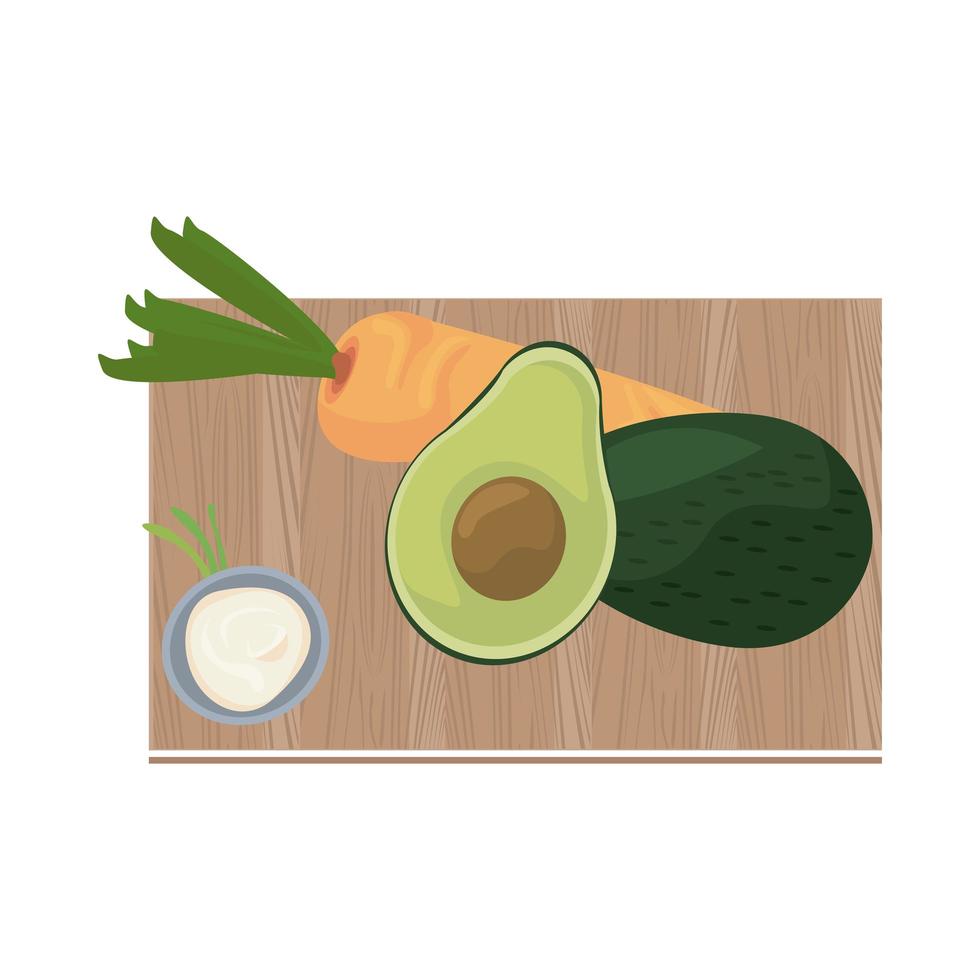 half avocado and carrot on wooden kitchen board vector