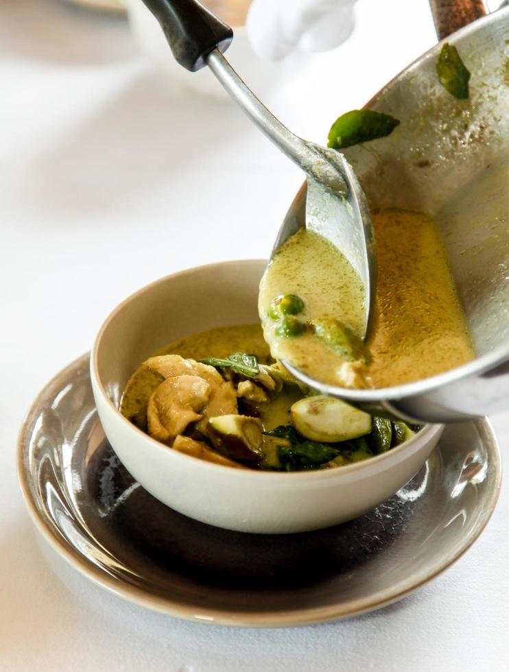 Soup being placed in a bowl photo