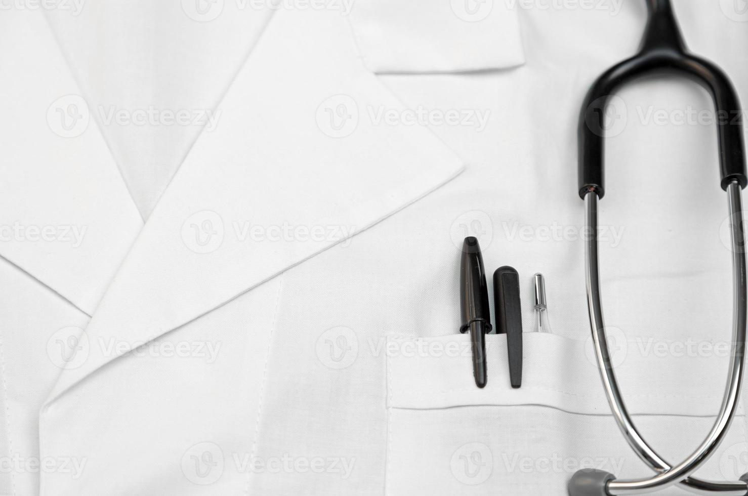 Doctor scrubs with a stethoscope, thermometer, and pens in the pocket photo