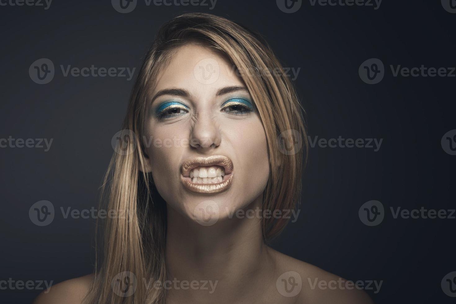 Beauty portrait of a young sexy woman against a dark blue background photo