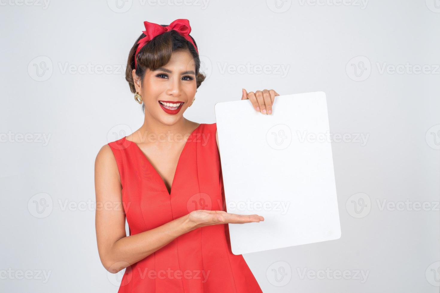 Portrait of a fashionable woman displaying a white banner photo