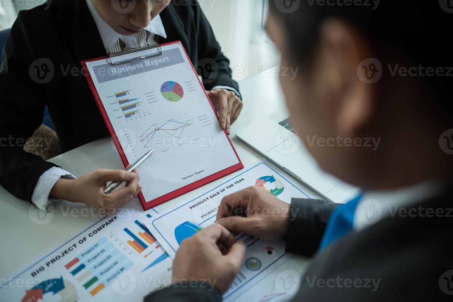 Close-up of business people working together photo