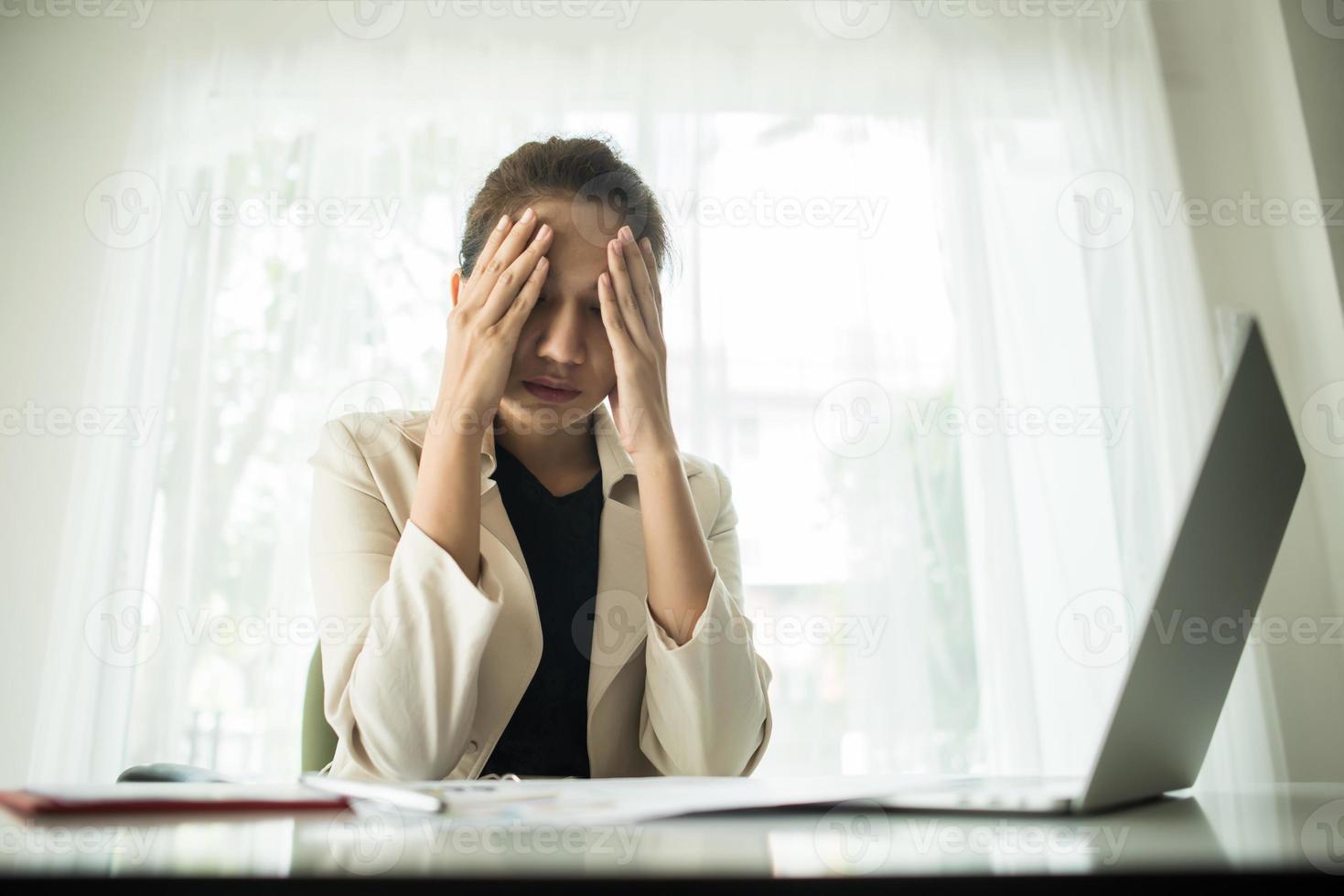 Young businessperson suffering from a headache photo