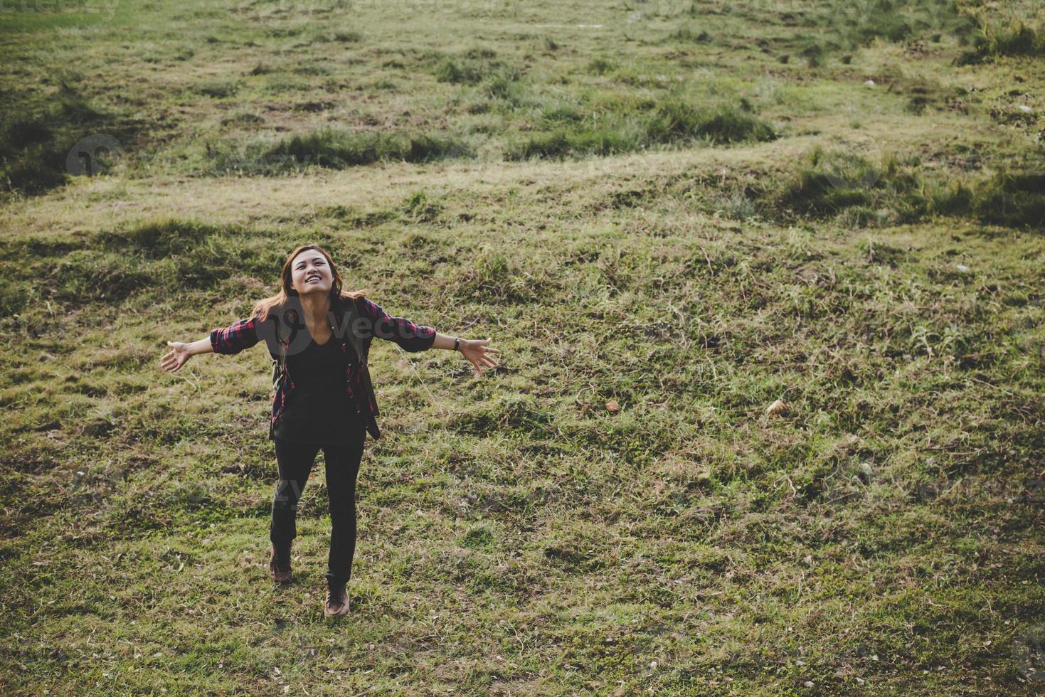 Hiker woman with backpack standing in nature photo