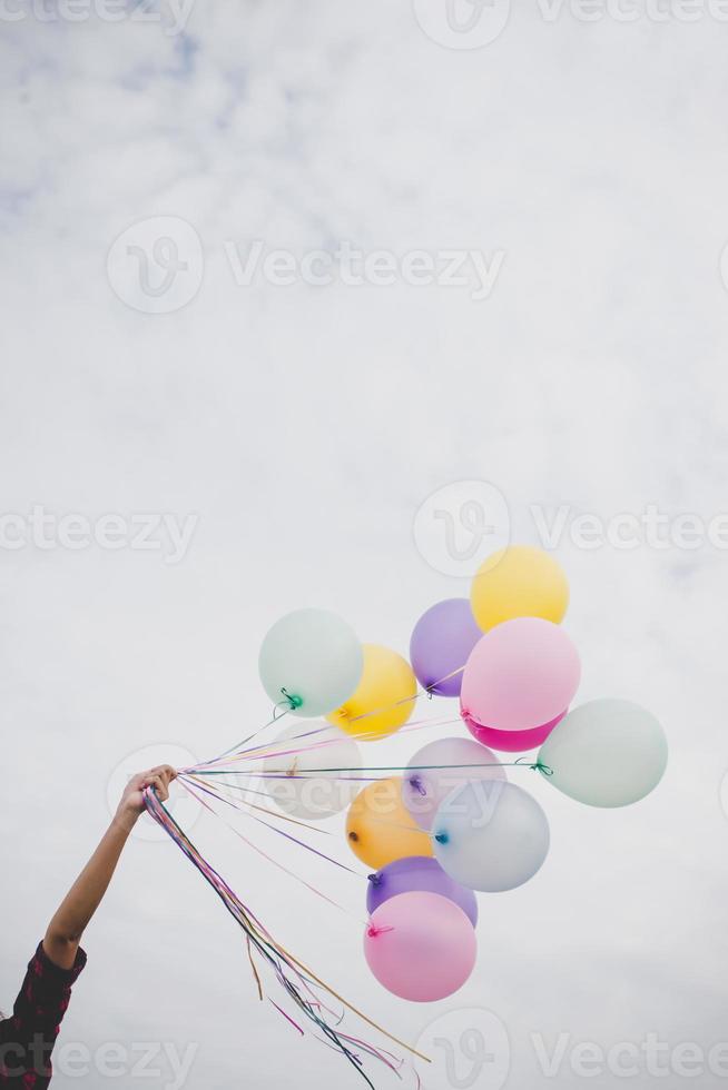Woman with colorful balloons outside photo
