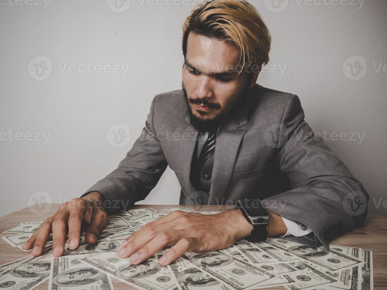 Happy businessman with dollar banknotes photo