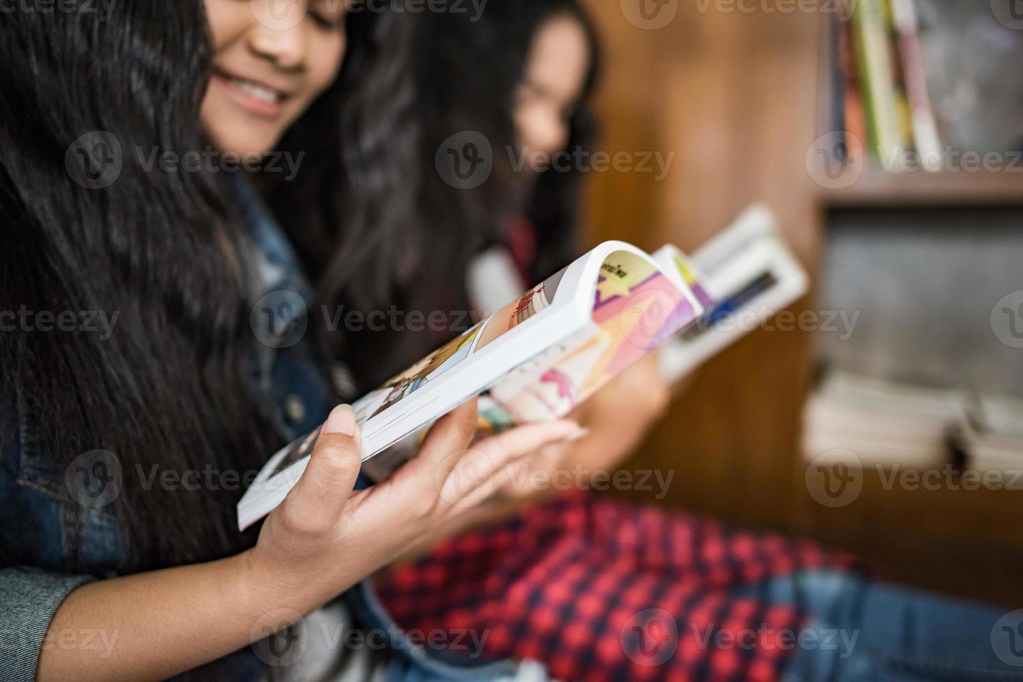 Female students reading books at the library photo