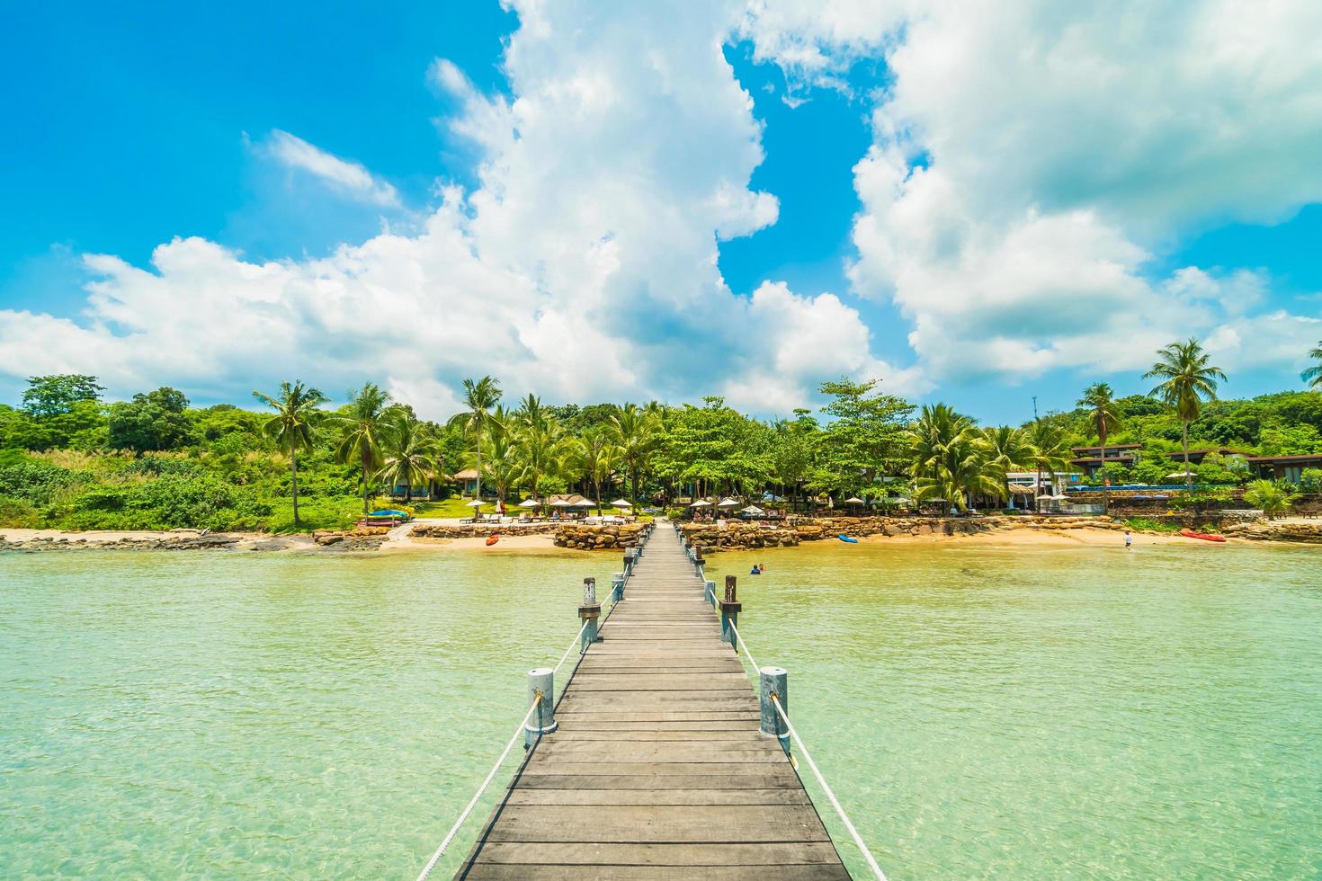 Wooden pier on tropical beach photo