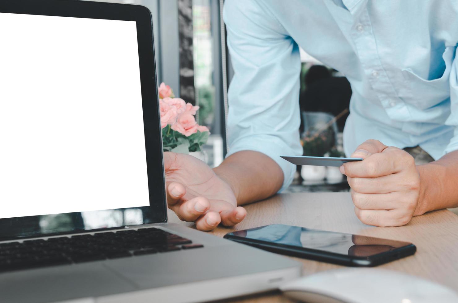 Businessman holding a credit card with computer laptop on the table. Shop online and make payment transactions business concept photo