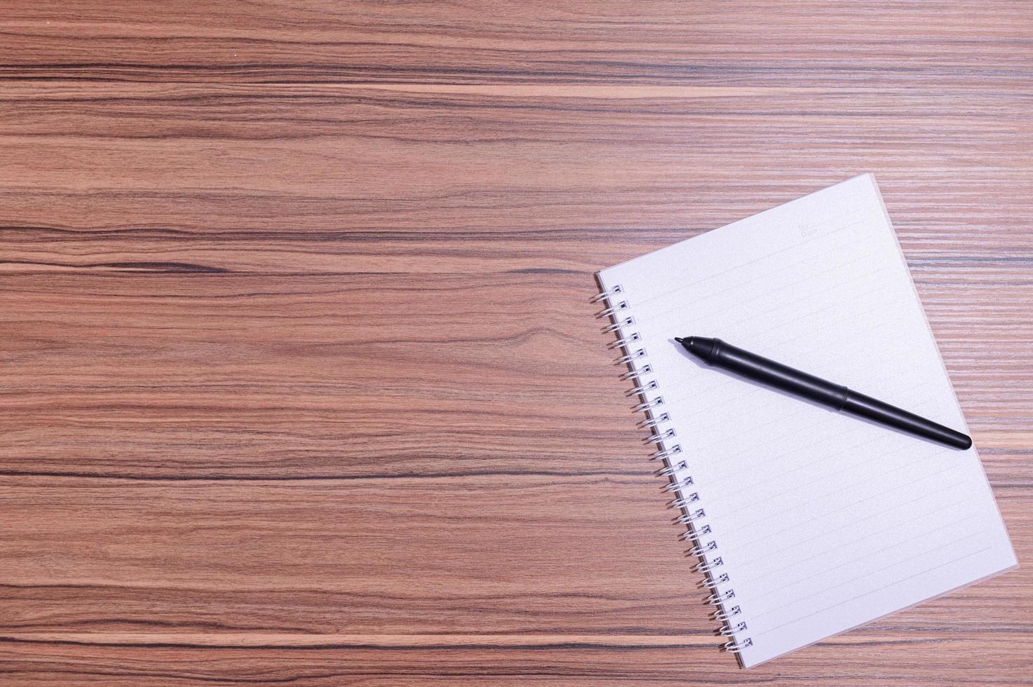 Notebook and pen on the table photo