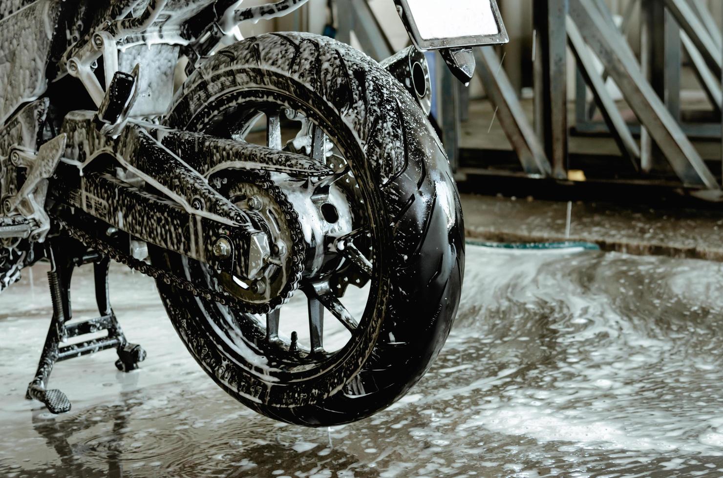 Washing a motorbike at the car wash shop photo