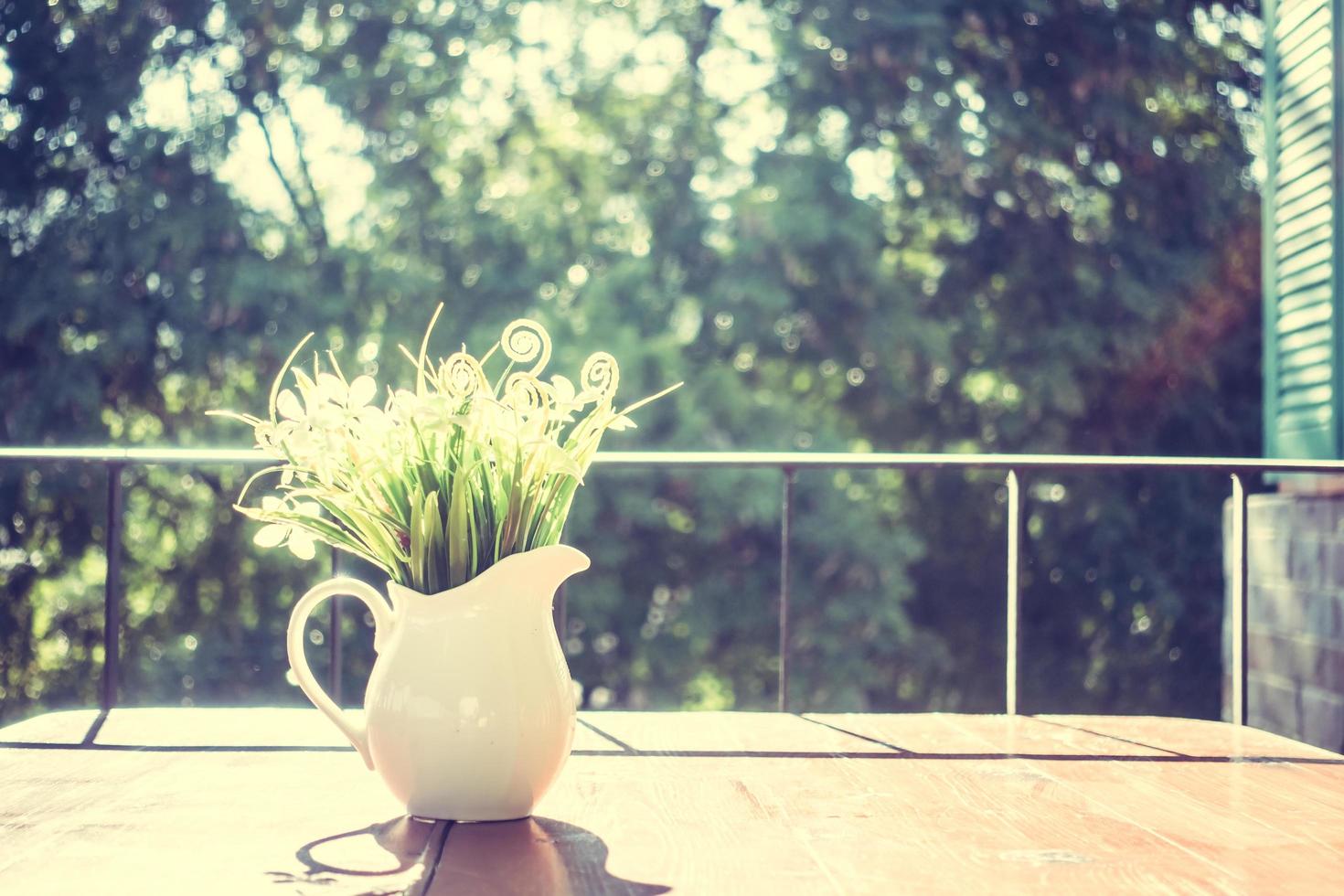 Vase and flowers on the table photo