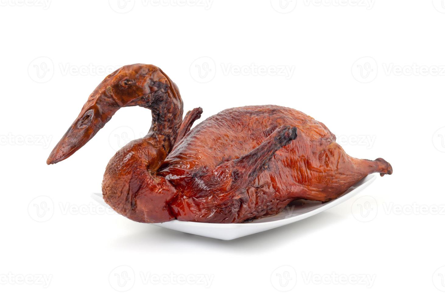 Whole roasted duck on white plate and white background photo