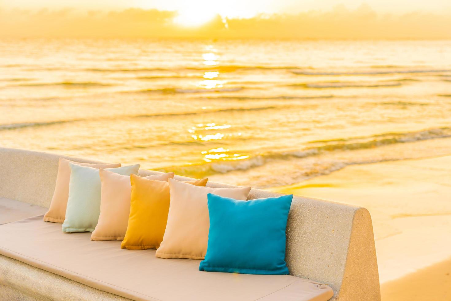 Comfortable pillow on sofa chair with ocean beach view photo