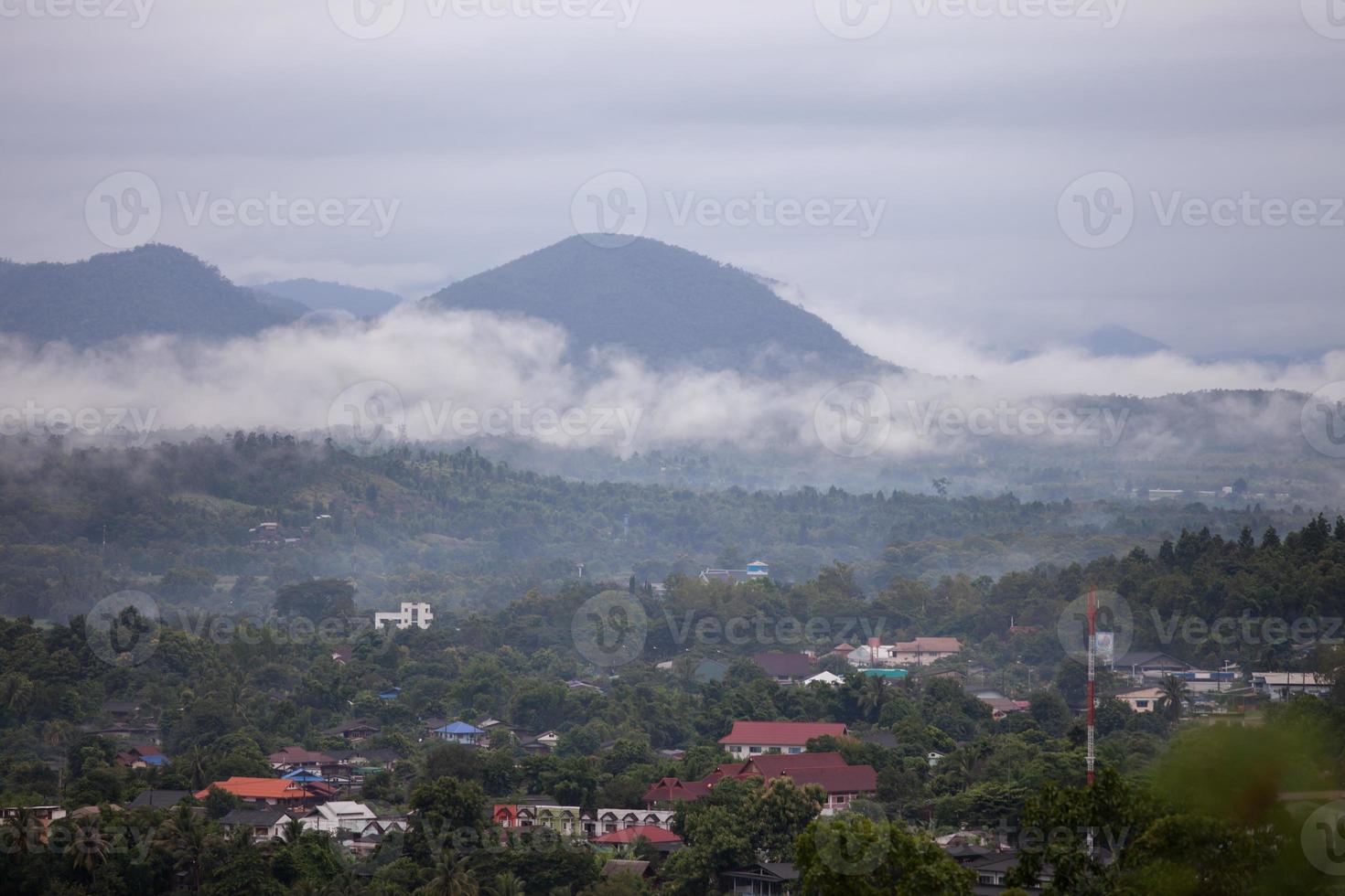 Foggy village on a hill photo