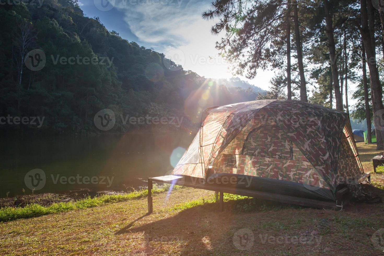 Tent in sunlight near mountains photo
