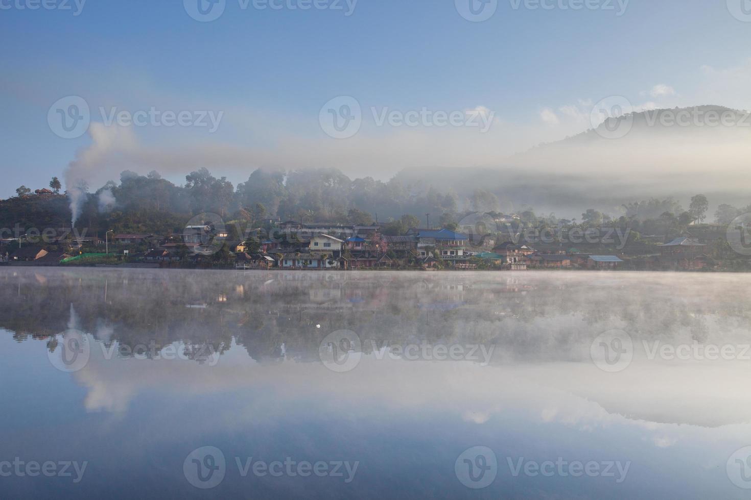 Fog and village reflection in water photo