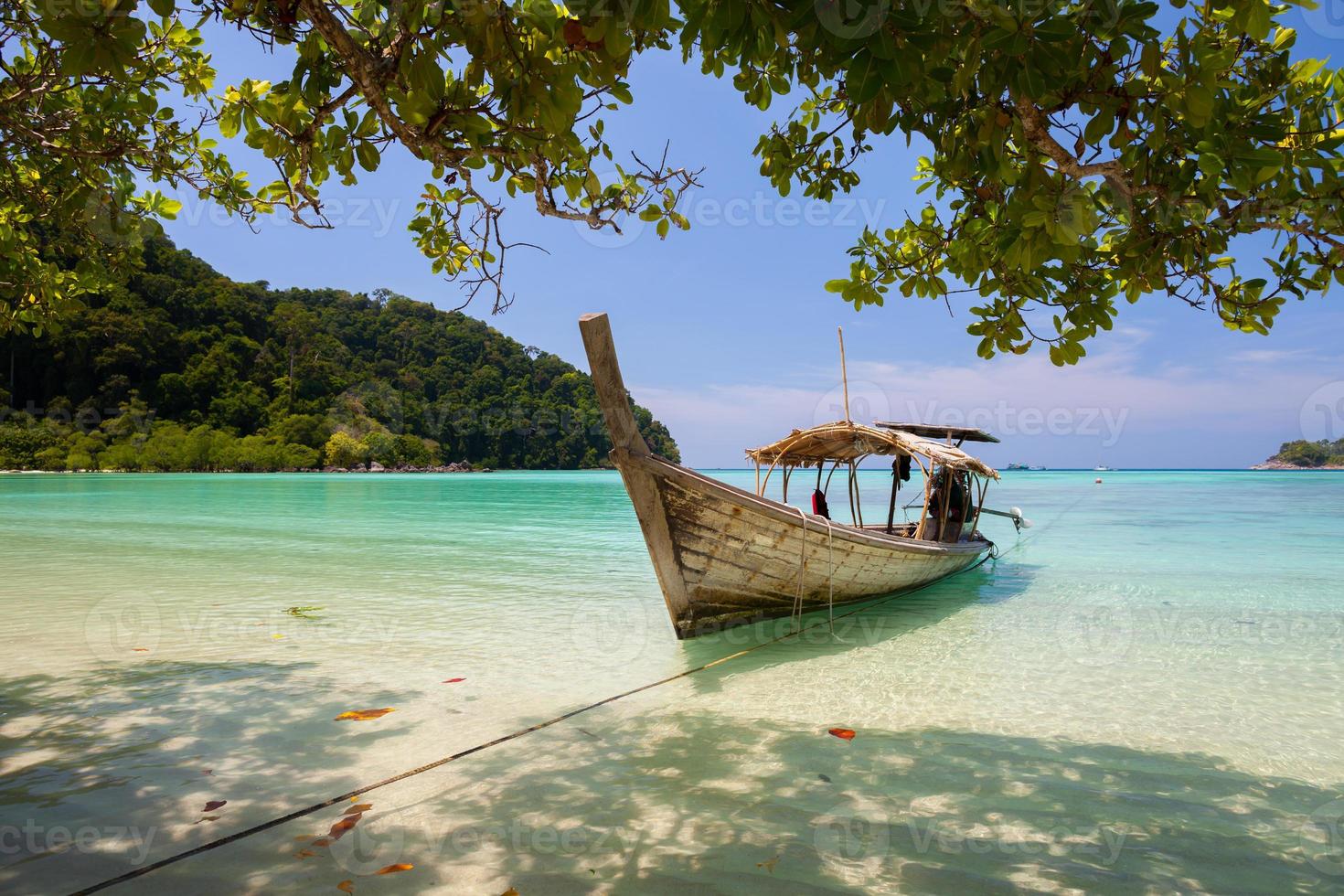 Longboat on a tropical beach photo