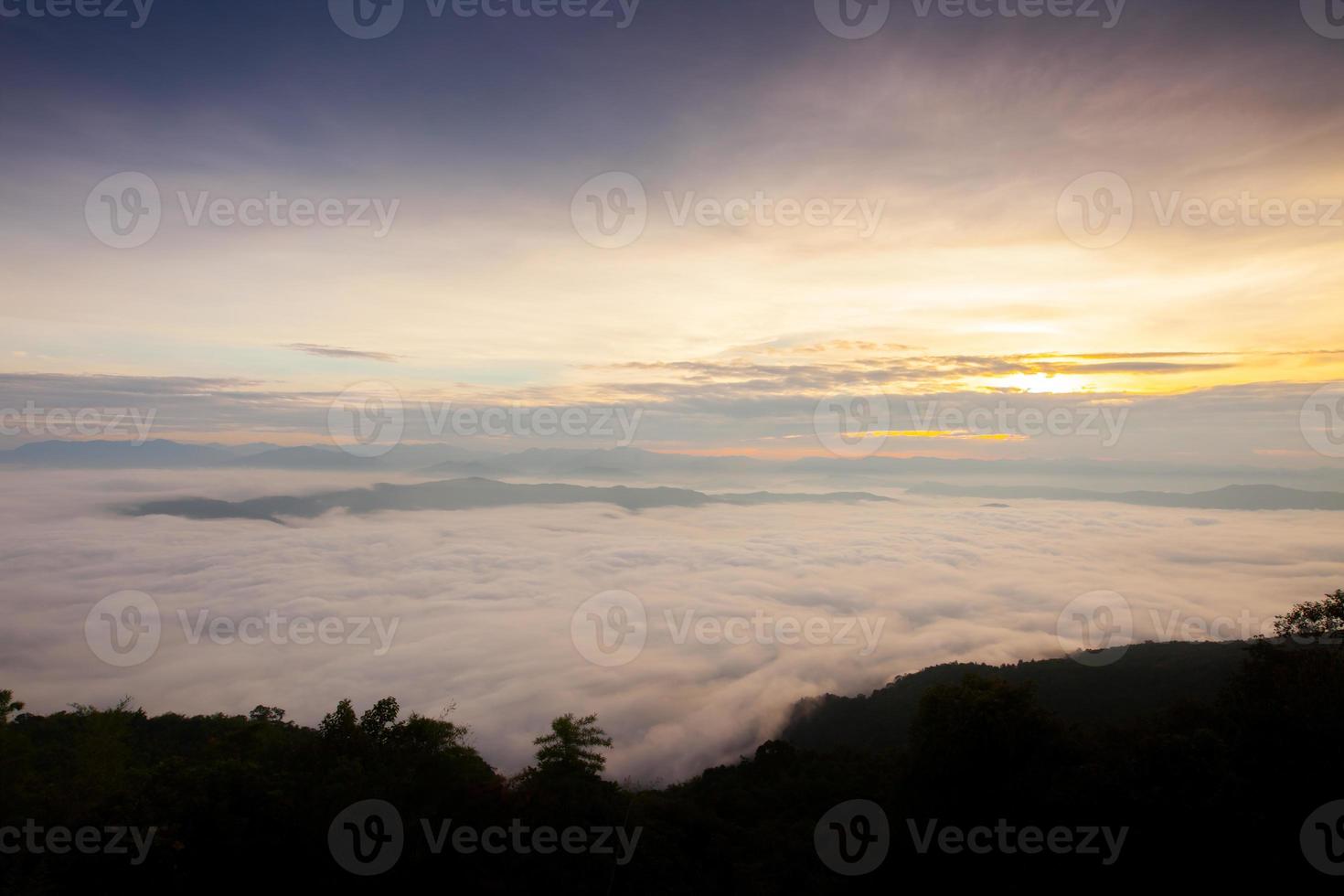 Fog over mountains at sunrise photo