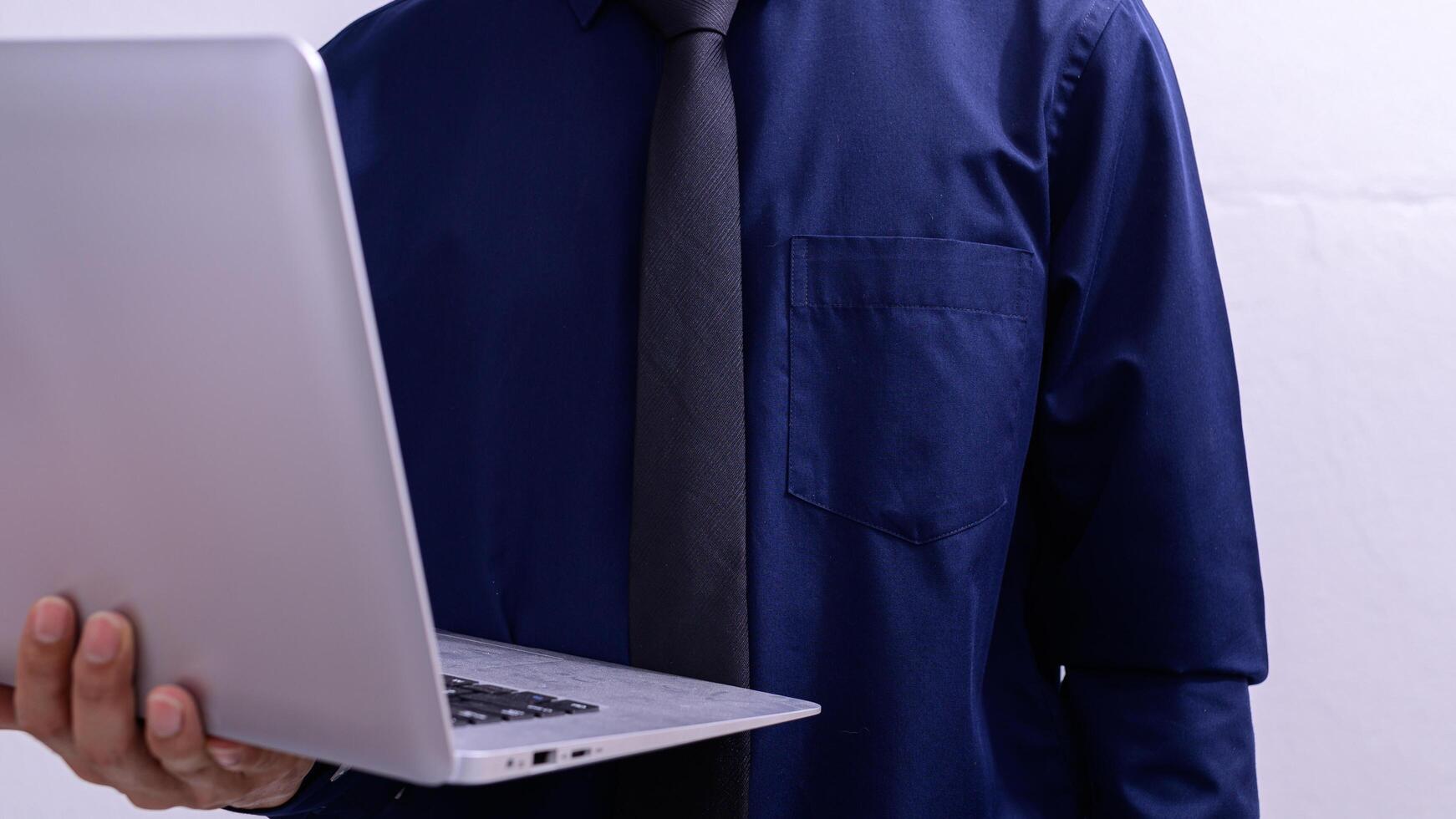 A person holding a laptop photo