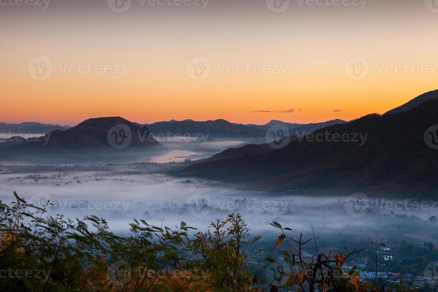 Sunrise above mountains and clouds photo