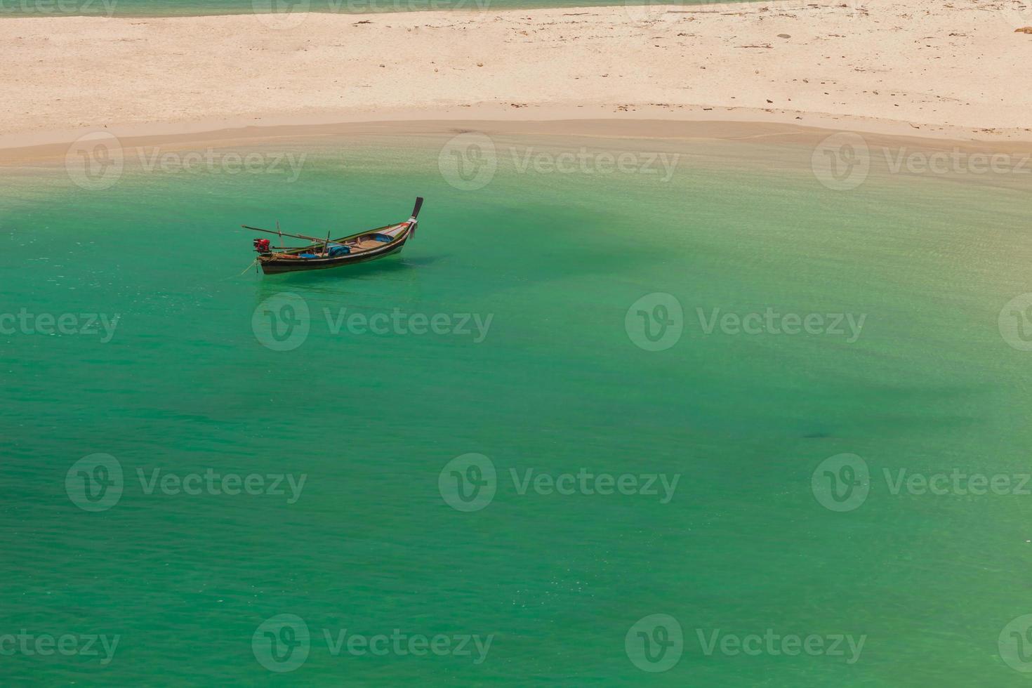 Boat floating near a beach photo