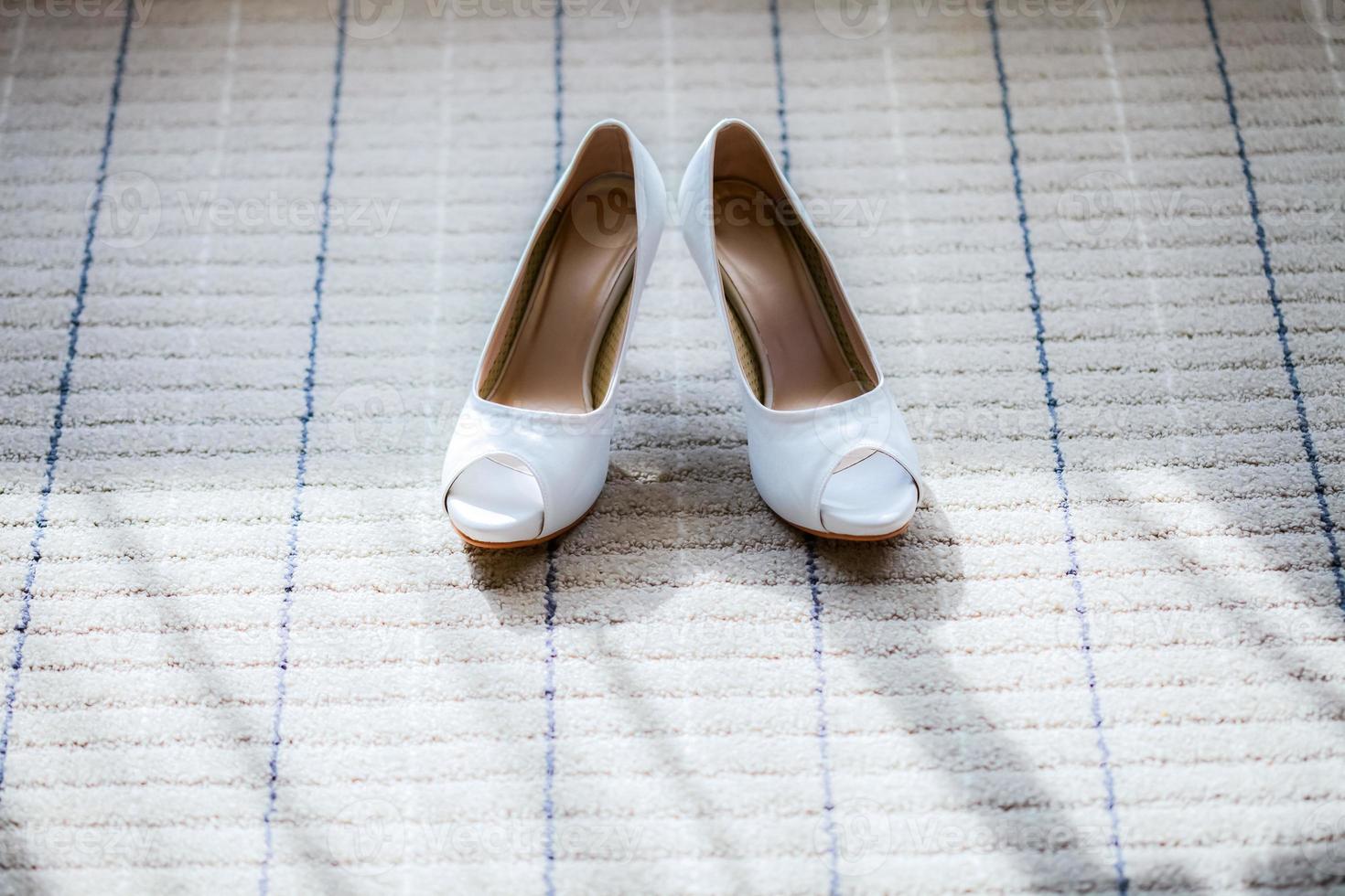 Bridal shoes on the ground photo