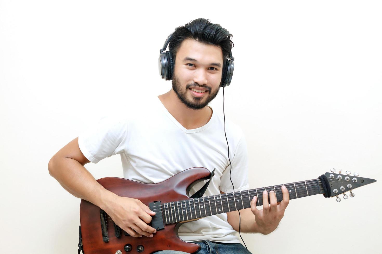 Young Asian man playing guitar photo