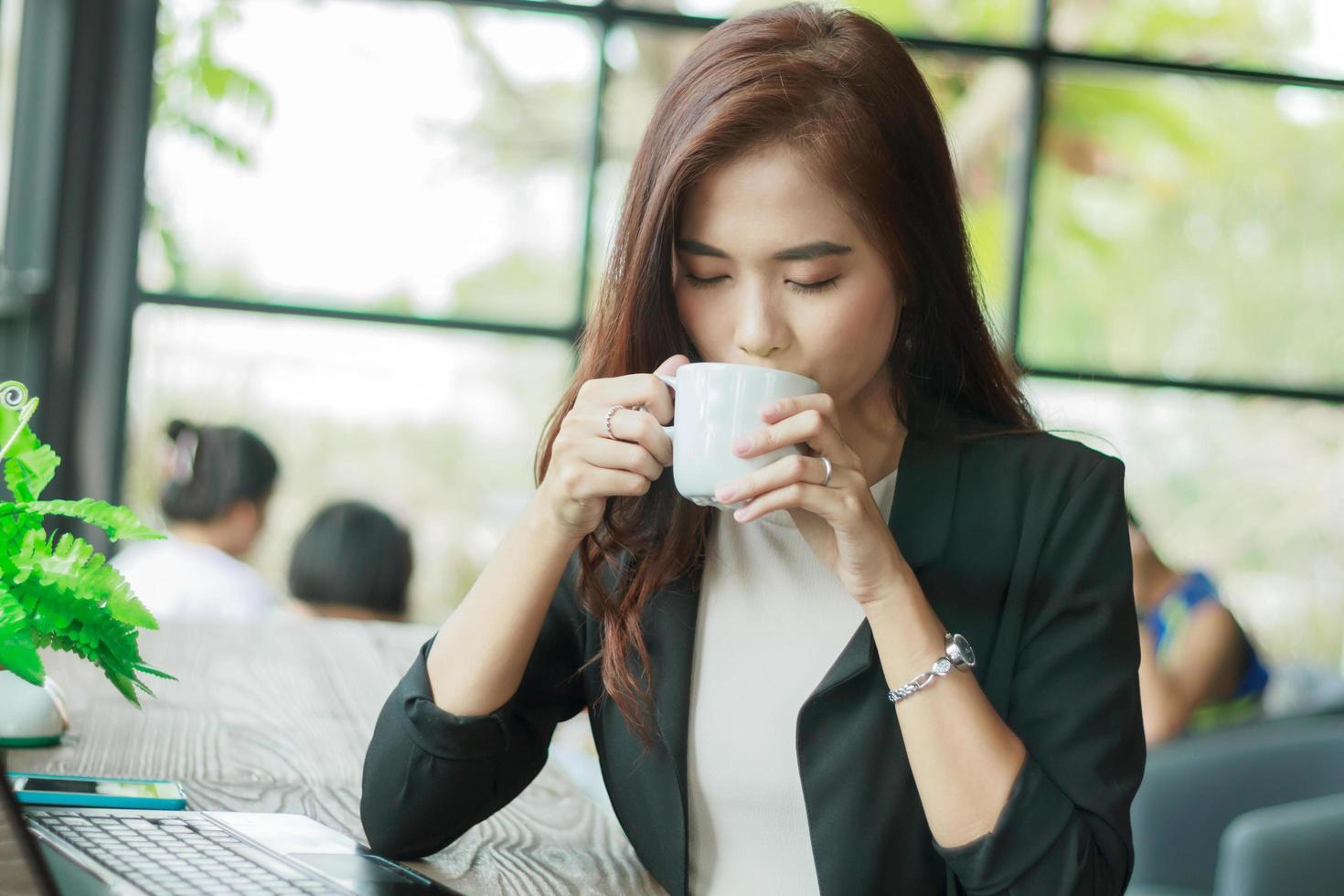 Asian business woman drinking coffee photo