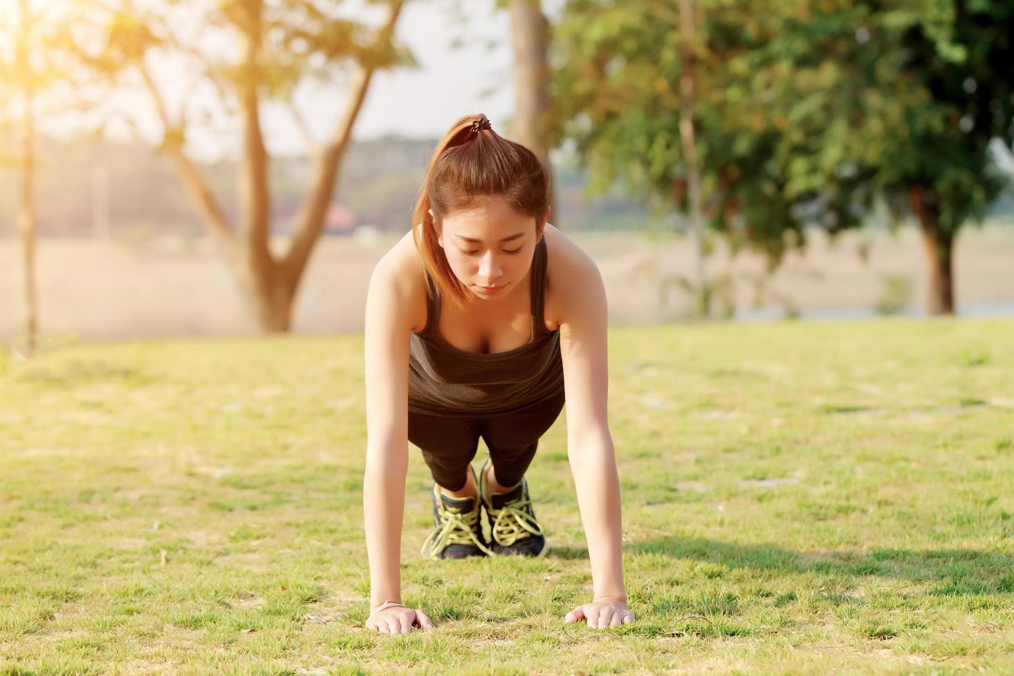 Athletic woman warming up in plank position photo