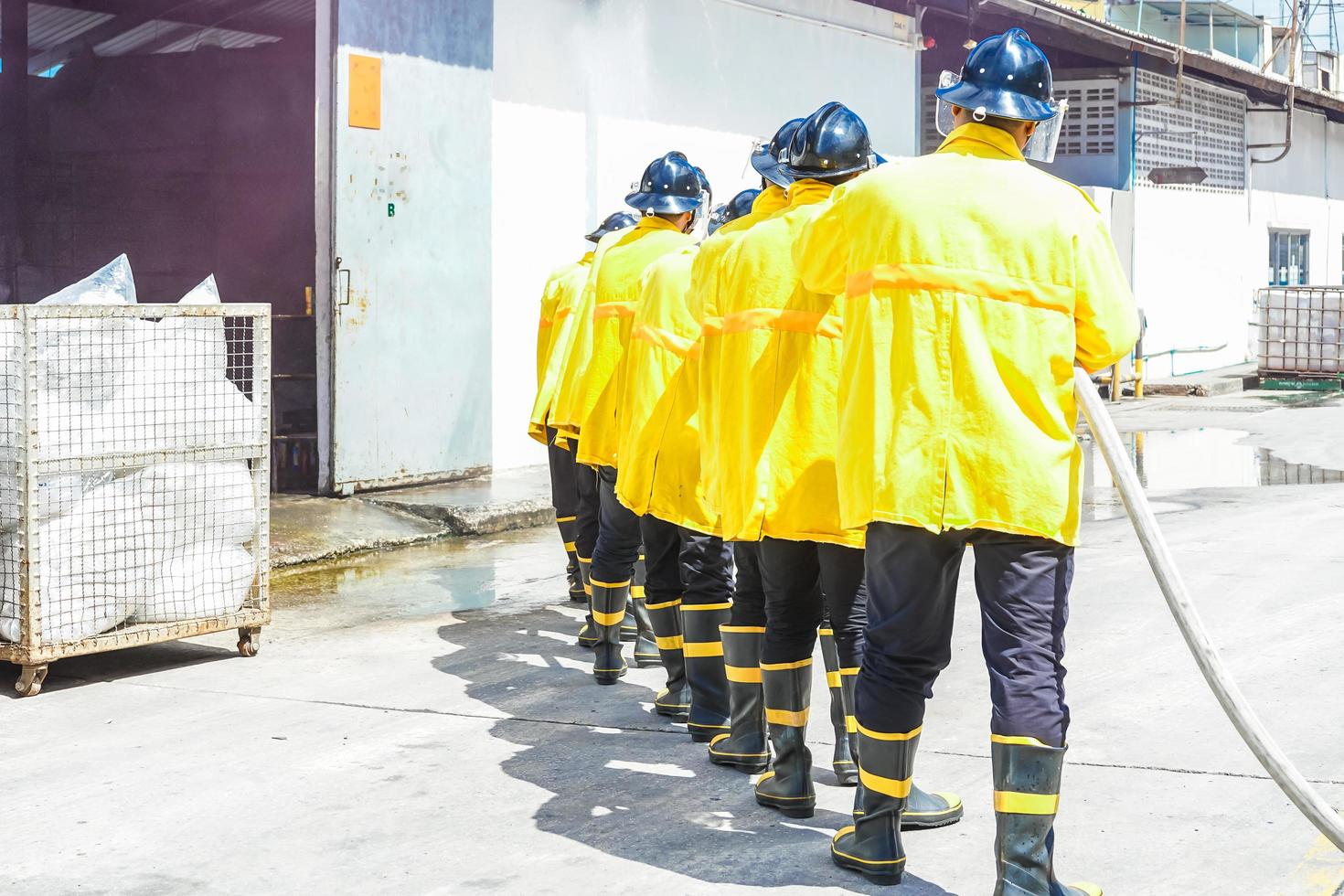 Firefighters using extinguisher and water photo