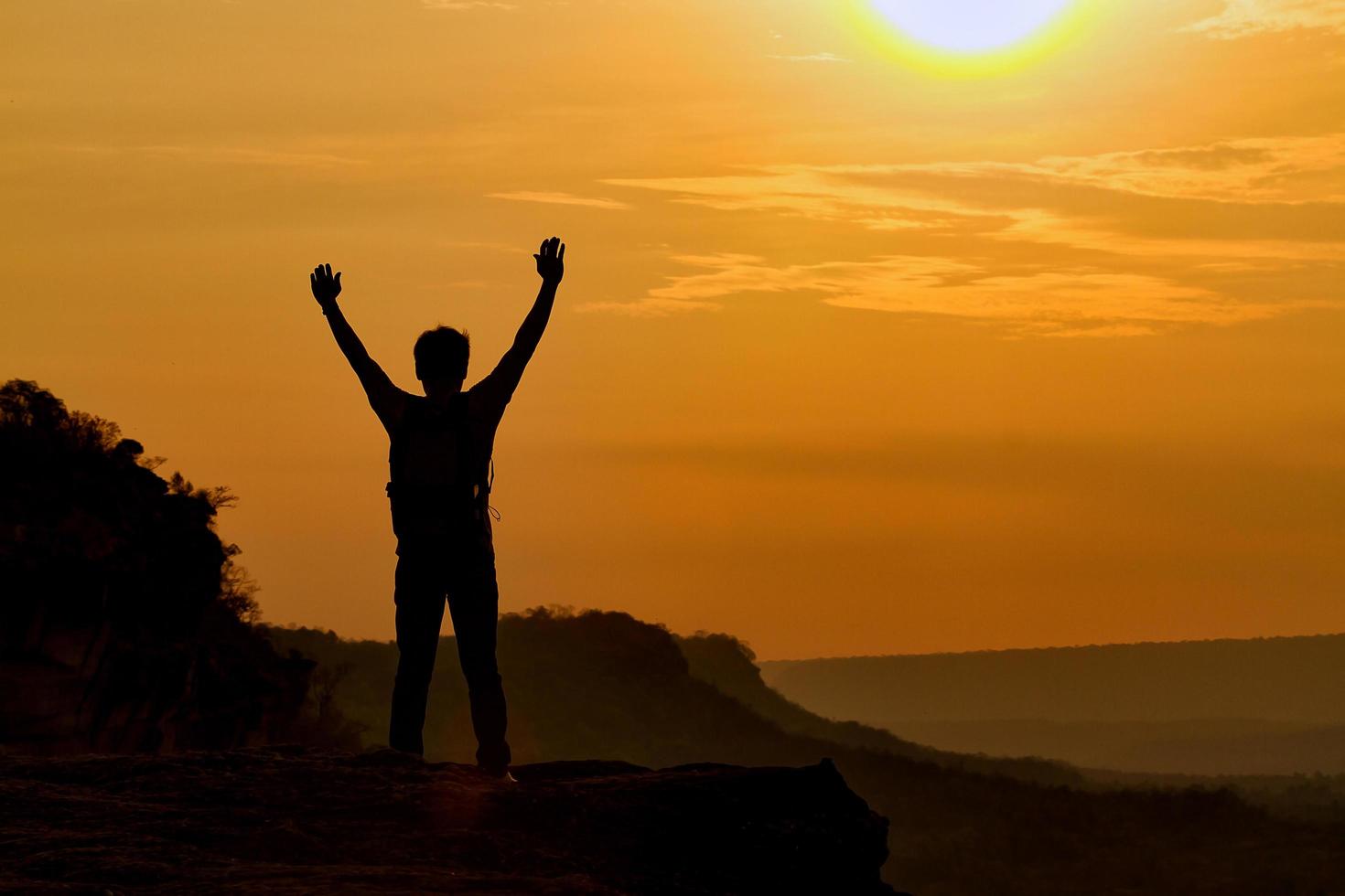 Silhouette of a man on a mountain photo