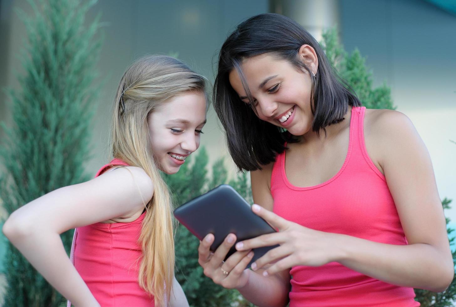 Two girls having fun using a tablet photo