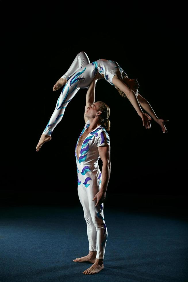 Man and woman gymnasts performing together photo