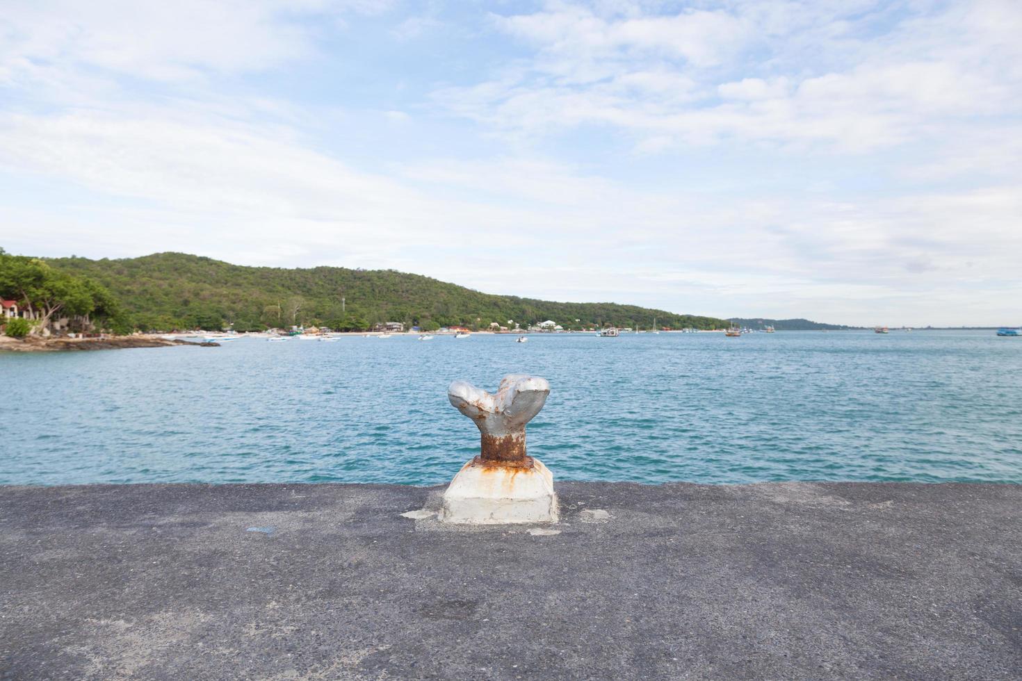 Mooring pole on the shore photo