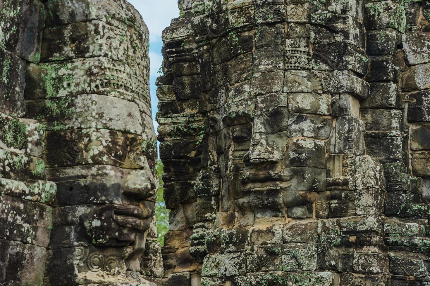 Ancient stone faces of Bayon temple, Angkor Wat, Siam Reap, Cambodia photo