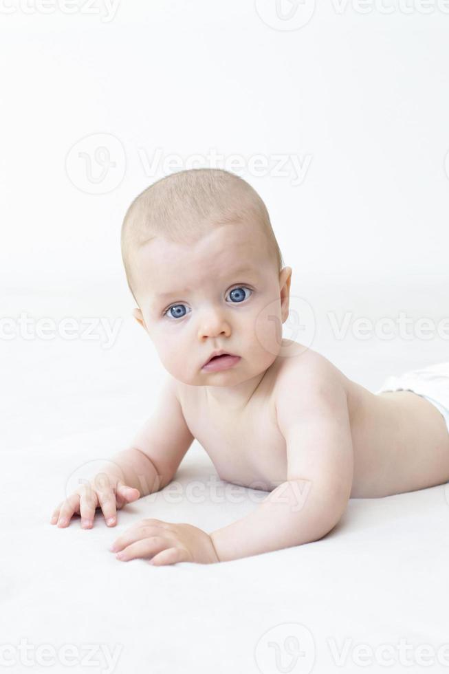 Cute baby girl lying on bed photo