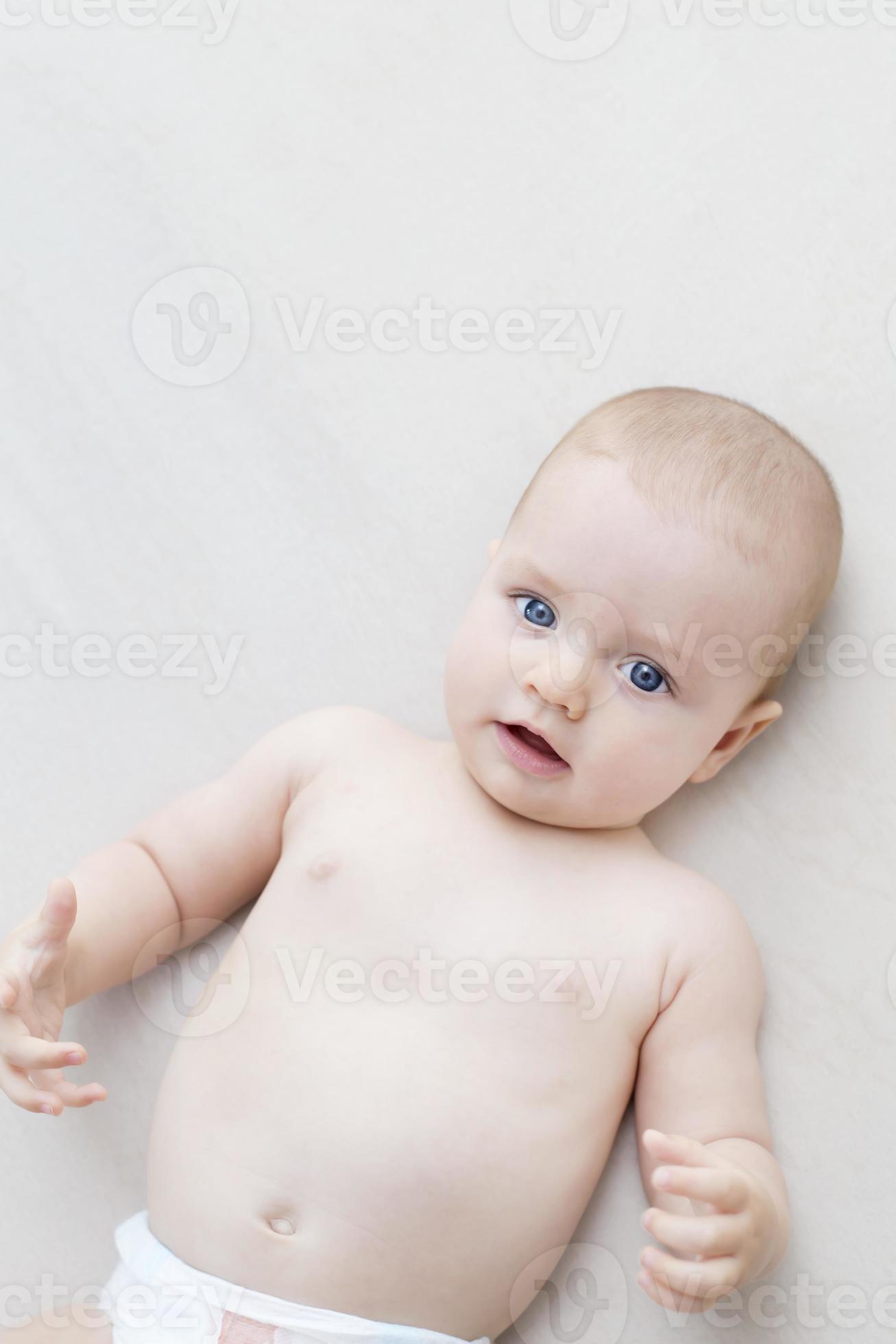  Cute baby girl lying on bed 2021953 Stock Photo at Vecteezy